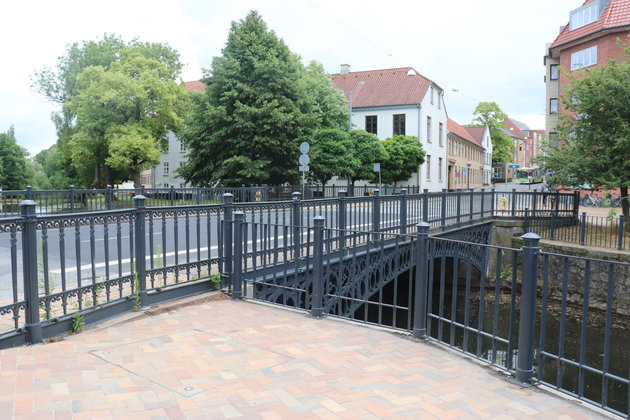 Foto af Frederiksbroen, hvor bilerne kan passere over Odense Å i den smalle gade.