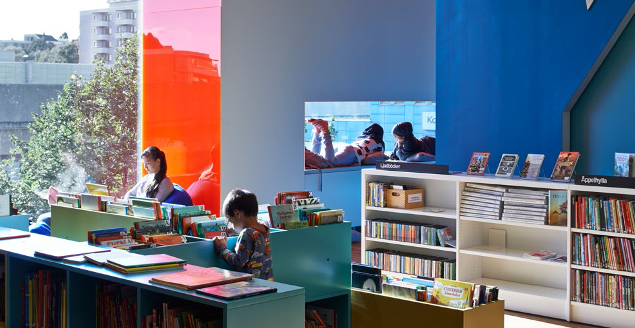 Børn på bibliotek med farver på væggene. Foto: Kista